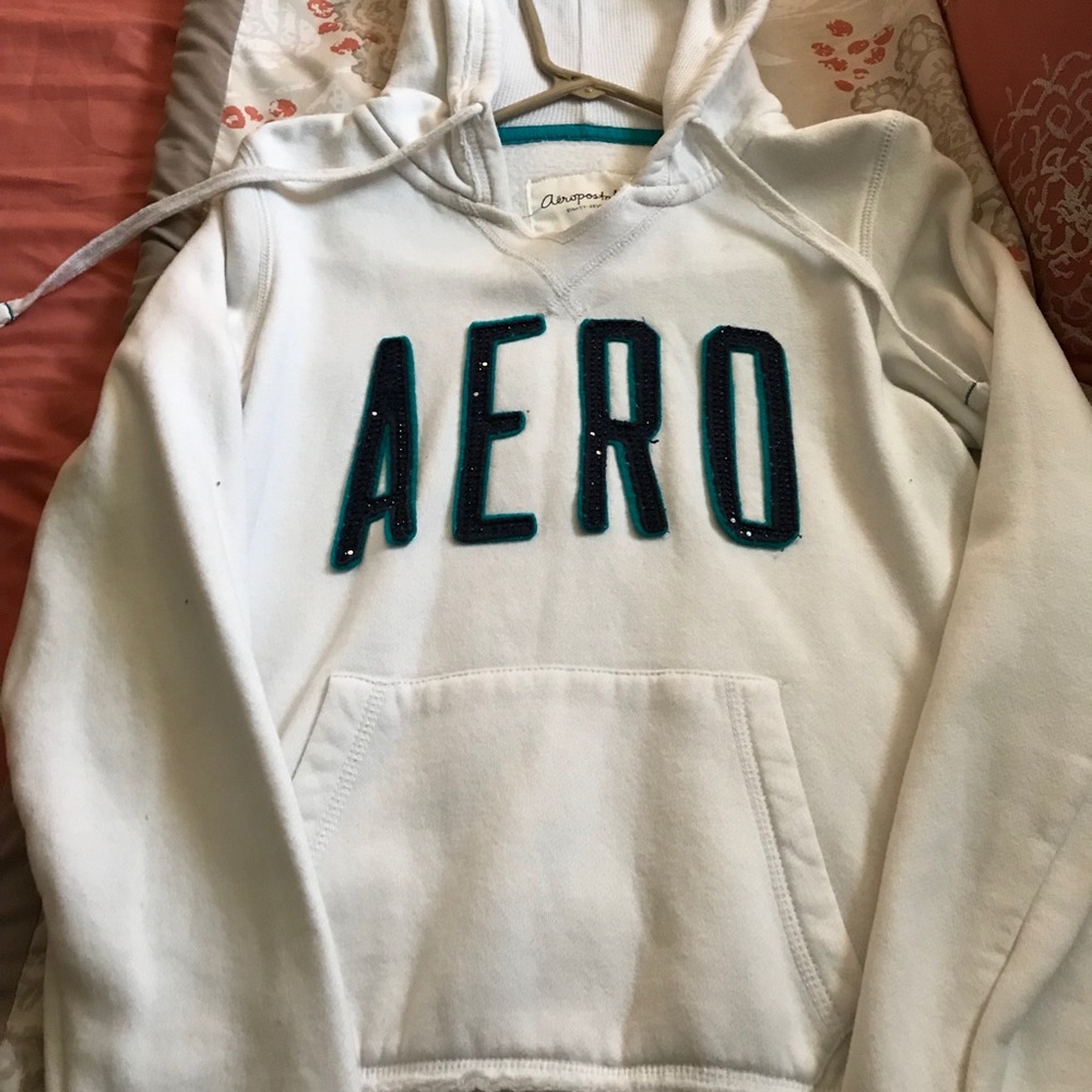 A white with blue sweater